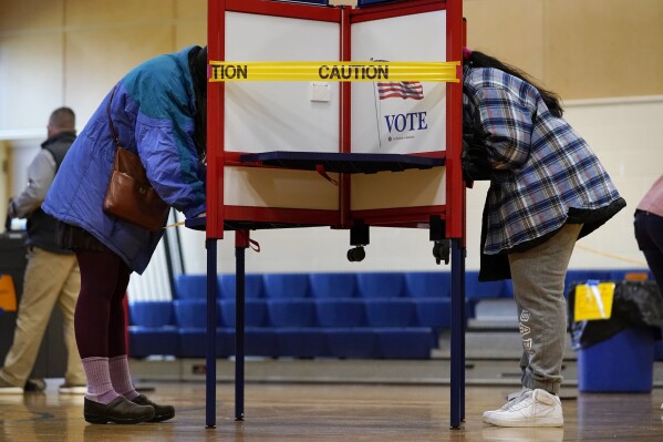 FILE - Residents vote on Election Day at the East End School, Tuesday, Nov. 3, 2020, in Portland, Maine. Maine's vaunted independent voters are becoming scarcer as Super Tuesday approaches. (AP Photo/Robert F. Bukaty, File)