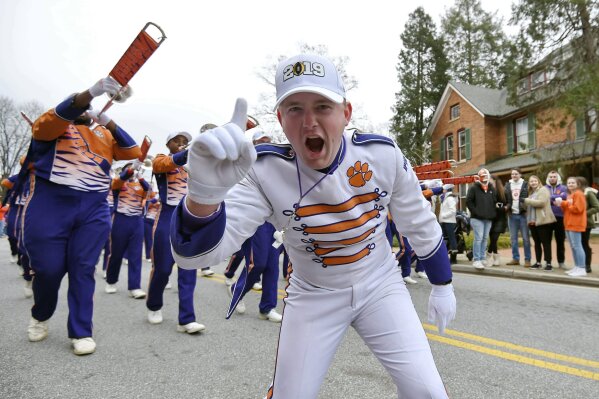 FILE - In this Jan. 12, 2019, file photo, a Clemson band member shows his excitement during a parade honoring Clemson for winning the College Football Playoff championship game against Alabama, in Clemson, S.C. For the first time, the defending national champion Tigers are No. 1 in The Associated Press preseason Top 25 presented by Regions Bank, Monday, Aug. 19, 2019. (AP Photo/Richard Shiro, File)