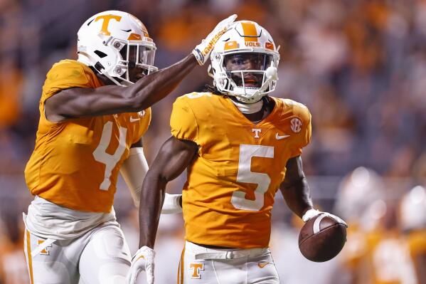 Tennessee defensive back Kamal Hadden (5) is congratulated by defensive back Warren Burrell (4) after intercepting a Ball State pass during the first half of an NCAA college football game Thursday, Sept. 1, 2022, in Knoxville, Tenn. (AP Photo/Wade Payne)