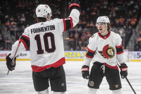 Ottawa Senators' Alex Formenton (10) and Adam Gaudette (17) celebrate a goal against the Edmonton Oilers during the third period of an NHL hockey game, Saturday, Jan. 15, 2022 in Edmonton, Alberta. (Jason Franson/The Canadian Press via AP)