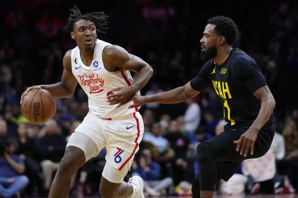 Philadelphia 76ers' Tyrese Maxey, left, tries to get past Utah Jazz's Mike Conley during the first half of an NBA basketball game, Sunday, Nov. 13, 2022, in Philadelphia. (AP Photo/Matt Slocum)