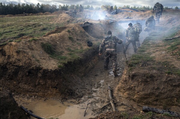 Ukrainian infantrymen train with French soldiers to learn combat skills, in France, Tuesday, Nov. 7, 2023. With the full-scale war grinding into a second winter, and casualties already counted in the hundreds of thousands continuing to mount on both sides, the training has become crucially important for Ukraine's chances of victory. (AP Photo/Laurent Cipriani)