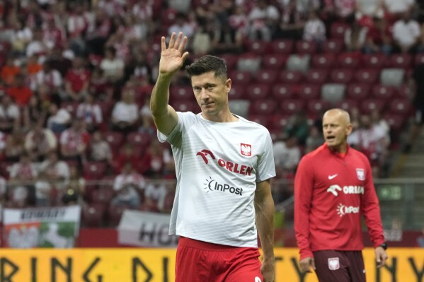 FILE - Poland's Robert Lewandowski greets supporters ahead the international friendly soccer match between Poland and Ukraine at the National stadium in Warsaw, Poland, on June 7, 2024. Poland will have to play its opening game at the European Championship against the Netherlands on Sunday June 16, 2024 without its striker Robert Lewandowski who will miss it out due to a muscle injury. (AP Photo/Czarek Sokolowski, File)