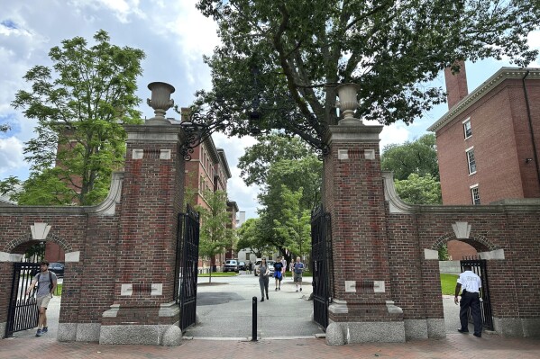 Students walk through a gate at Harvard University, Thursday, June 29, 2023, in Cambridge, Mass. The Supreme Court on Thursday struck down affirmative action in college admissions, declaring race cannot be a factor and forcing institutions of higher education to look for new ways to achieve diverse student bodies. (AP Photo/Michael Casey)