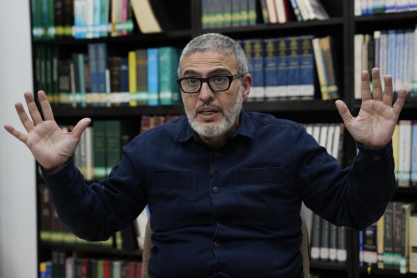 Doctor Ghassan Abu Sitta, a Palestinian-British plastic surgeon specializing in conflict medicine, speaks during an interview with The Associated Press at the Institute for Palestine Studies in Beirut, Lebanon, Saturday, Dec. 9, 2023. Abu Sitta who spent weeks in the Gaza Strip during the current Israel-Hamas war in the enclave as part of a Doctors Without Borders medical team said he has given testimony to a British war crimes investigation unit. (AP Photo/Hussein Malla)