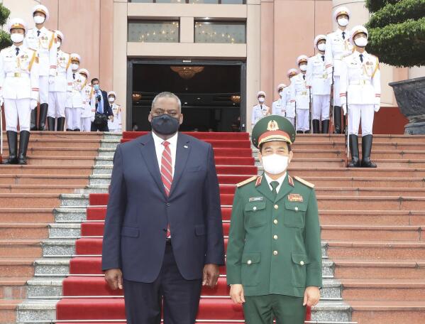 U.S Defense Secretary Lloyd Austin and Vietnamese Defense Minister Phan Van Giang stand for a photo in Hanoi, Vietnam, Thursday, July 29, 2021. Austin is seeking to bolster ties with Vietnam, one of the Southeast Asian nations embroiled in a territorial rift with China, during a two-day visit. (Nguyen Trong Duc/VNA via AP)