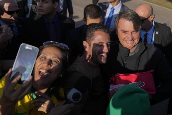 FILE - Brazil's President Jair Bolsonaro, who is running for a second term, greets supporters in Porto Feliz, Brazil, May 20, 2022. Bolsonaro is running against former President Luiz Inacio Lula da Silva, in the Oct. 2, presidential election. (AP Photo/Andre Penner, File)