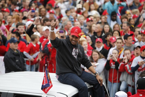 St. Louis Cardinals relief pitcher Octavio Dotel participates in a victory parade after defeating the Texas Rangers to win their 11th World Series in franchise history Sunday, Oct. 30, 2011, in St. Louis. (AP Photo/Jeff Roberson, File)