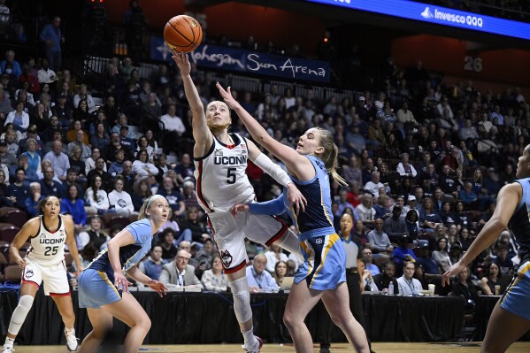 UConn guard Paige Bueckers makes a basket as Marquette guard Lee Volker, right, defends during the first half of an NCAA college basketball game in the semifinals of the Big East Conference tournament, Sunday, March 10, 2024, in Uncasville, Conn. (AP Photo/Jessica Hill)