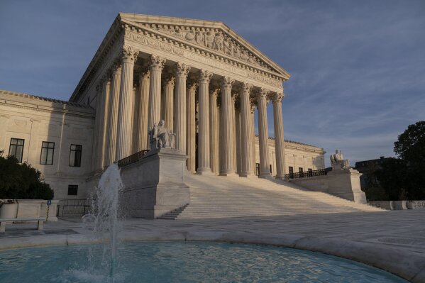 FILE - In this Nov. 5, 2020 file photo, the Supreme Court is seen in Washington.  The Supreme Court will take up challenges to controversial Trump administration policies affecting family-planning clinics and immigrants, even though the Biden administration has announced it is reviewing them. (AP Photo/J. Scott Applewhite)