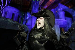 FILE - In this Sept. 12, 2018 file photo, Laura Law performs as a witch at the Scary Tales haunted house at Halloween Horror nights at Universal Studios in Orlando, Fla. After a pandemic-related absence of almost two years, Universal Orlando Resort's celebration of all things scary opened for screams on Friday, Sept. 3, 2021. Halloween Horror Nights kicked off at the Florida theme park resort for a 30th year of disturbing haunted houses, live entertainment and celebrations of pop-culture scares. (AP Photo/John Raoux, File)