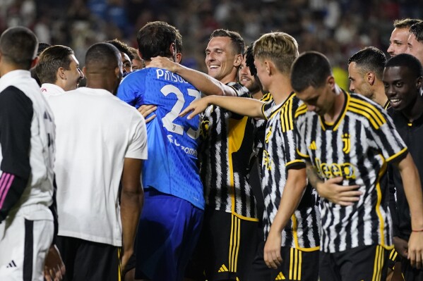 Juventus FC goal keeper Carlo Pinsoglio (23) celebrates with teammates after winning a Champions Tour soccer match against AC Milan, Thursday, July 27, 2023, in Carson, Calif. (AP Photo/Ashley Landis)
