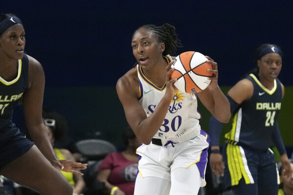 Los Angeles Sparks forward Nneka Ogwumike (30) looks to pass against Dallas Wings center Kalani Brown (21) during the first half of a WNBA basketball basketball game in Arlington, Texas, Wednesday, June 14, 2023. (AP Photo/LM Otero)