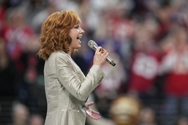 Reba McEntire performs the national anthem before the NFL Super Bowl 58 football game between the San Francisco 49ers and the Kansas City Chiefs, Sunday, Feb. 11, 2024, in Las Vegas. (AP Photo/Brynn Anderson)