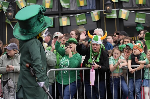 Michele Hunter, of Pawlet, Vt., center left, and Erin Riley, of Saugus, Mass., cheer a performer at the St. Patrick's Day parade, Sunday, March 16, 2025, in Boston, Mass. (AP Photo/Robert F. Bukaty)