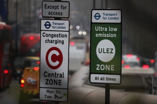 FILE- Cars enter the Ultra Low Emission Zone that has come into force in London, Monday, April 8, 2019. A British court ruled against five London suburbs that tried to block a pollution tax on older cars in what is becoming a key issue in British politics as the dramatic impacts of climate change are being seen around the planet on Friday, July 28, 2023. (AP Photo/Frank Augstein, File)