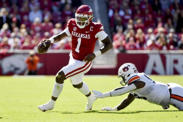 Arkansas quarterback KJ Jefferson (1) slips past Auburn defender J.J. Pegues (89) as he runs the ball during the first half of an NCAA college football game Saturday, Oct. 16, 2021, in Fayetteville, Ark. (AP Photo/Michael Woods)