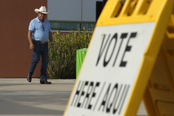 A voter leaves a precinct after casting their ballot in the state's primary election, Tuesday, July 30, 2024, in El Mirage, Ariz. (AP Photo/Ross D. Franklin)