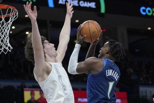 Minnesota Timberwolves forward Anthony Edwards (1) shoots as Oklahoma City Thunder guard Josh Giddey defends during the first half of an NBA basketball game Friday, Jan. 7, 2022, in Oklahoma City. (AP Photo/Sue Ogrocki)
