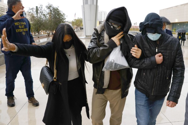 FILE - Alexander Smirnov, second from right, leaves the courthouse on Feb. 20, 2024, in Las Vegas. (Bizuayehu Tesfaye/Las Vegas Review-Journal via AP, File)