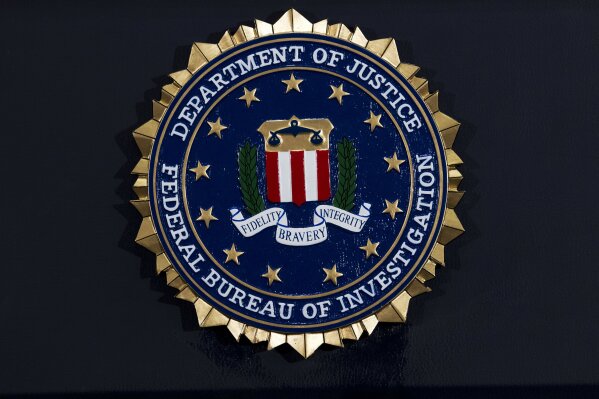 FILE - This Thursday, June 14, 2018, file photo, shows the FBI seal at a news conference at FBI headquarters in Washington. The FBI has been shaken by a series of sexual misconduct cases involving senior leadership over the past few years, including two new claims brought in December 2020 by women who say they were sexually assaulted by supervisors. (AP Photo/Jose Luis Magana, File)