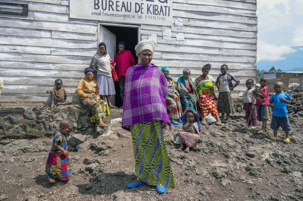 Pasika Bagerimana stands outside a temporary shelter she shares with others who fled fighting, in Nyiragongo, Democratic Republic of Congo, Aug. 31, 2022. Bagerimana, who lost two children to hunger, worries her remaining two children might be next. "Hunger is killing people," she says. Hunger is soaring across parts of Congo's war-torn North Kivu province where the fighting between M23 rebels and government soldiers has been raging since March, according to aid workers, civilians and health workers. (AP Photo/Sam Mednick)