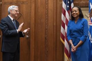 Kristen Clarke, newly sworn in as assistant attorney general for civil rights, reacts as she is congratulated by Attorney General Merrick Garland, left, Tuesday, May 25, 2021, at the Justice Department in Washington. (AP Photo/Jacquelyn Martin)