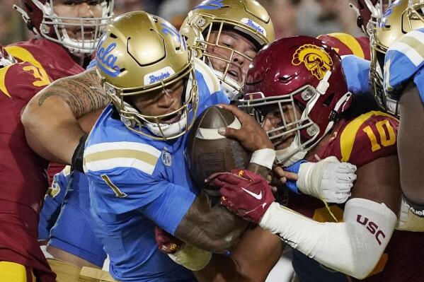 UCLA quarterback Dorian Thompson-Robinson (1) heads in for a touchdown as Southern California linebacker Ralen Goforth (10) tries to stop him during the first half of an NCAA college football game Saturday, Nov. 19, 2022, in Pasadena, Calif. (AP Photo/Mark J. Terrill)