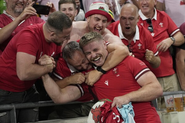 Wales' Aaron Wainwright celebrates with fans defeating Australia 40-6 during a Rugby World Cup Pool C match at the Parc OL stadium in Lyon, France, Sunday, Sept. 24, 2023. Wales qualified to the quarterfinals. (AP Photo/Laurent Cipriani)