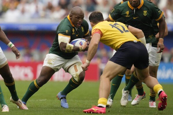 South Africa's Mbongeni Mbonambi, left, plays against Romania's Taylor Gontineac during the Rugby World Cup Pool B match between South Africa and Romania at the Stade de Bordeaux in Bordeaux, France, Sunday, Sept. 17, 2023. (AP Photo/Themba Hadebe)