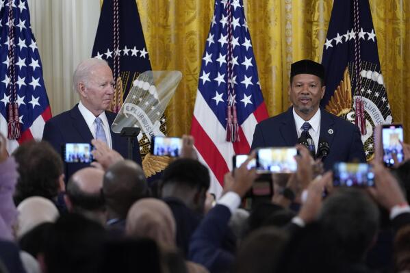 President Joe Biden, left, listens as Talib M. Shareef, right, President and Imam of the historic, Nation's Mosque, Masjid Muhammad in Washington, speaks during a reception to celebrate Eid al-Fitr in the East Room of the White House in Washington, Monday, May 2, 2022. (AP Photo/Susan Walsh)