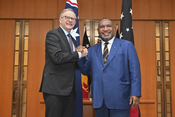 Australia's Prime Minister Anthony Albanese, left, meets with Papua New Guinea's Prime Minister James Marape at Parliament House in Canberra, Australia, Thursday, Dec. 7, 2023. The Australian government signed a security pact with its nearest neighbor Papua New Guinea on Thursday that strengthens Australia’s place as the preferred security partner in a region where China’s influence is growing. (Mick Tsikas/AAP Image via AP)