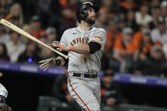 San Francisco Giants' Brandon Belt releases his bat after connecting for a solo home run off Colorado Rockies relief pitcher Ashton Goudeau in the sixth inning of a baseball game Friday, Sept. 24, 2021, in Denver. (AP Photo/David Zalubowski)
