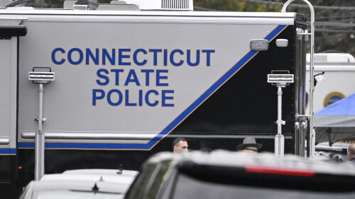 FILE - Members of the Connecticut State Police Major Crime Unit on scene where two police officers were killed, Oct. 13, 2022, in Bristol, Conn. Hundreds of Connecticut state police troopers falsified information on at least 26,000 traffic stops from 2014 to 2021, skewing reports on the race and ethnicity of pulled-over motorists, according to an audit released Wednesday, June 28, 2023. (AP Photo/Jessica Hill, File)