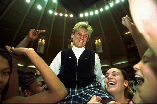 FILE - Virginia women's basketball coach Debbie Ryan is carried off the court by her players following their 73-55 victory over Florida State in Charlottesville, Va., Sunday, Feb. 21, 1999. The win was Ryan's 500th career victory at Virginia. Marsha Sharp, Ann Meyers Drysdale, Debbie Ryan and others all worked their way through the nascent days of Title IX to the heights of women’s basketball. (Landon Nordeman/The Daily Progress via AP, File)