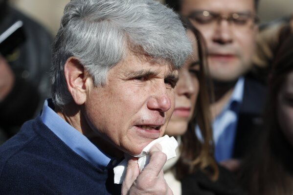 Former Illinois Gov. Rod Blagojevich dabs blood from his chin during a news conference outside his home Wednesday, Feb. 19, 2020, in Chicago. On Tuesday, President Donald Trump commuted Blagojevich's 14-year prison sentence for political corruption. Blagojevich joked that it was the first time in a long time he has shaved with a normal razor. (AP Photo/Charles Rex Arbogast)