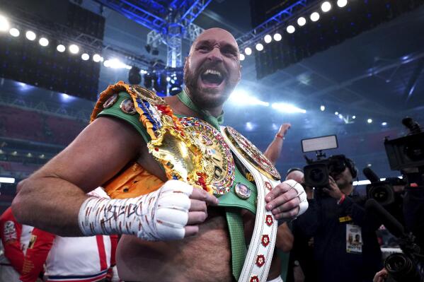 Britain’s Tyson Fury celebrates after beating Britain’s Dillian Whyte to win their WBC heavyweight title boxing fight at Wembley Stadium in London, Saturday, April 23, 2022. (Nick Potts/PA via AP)