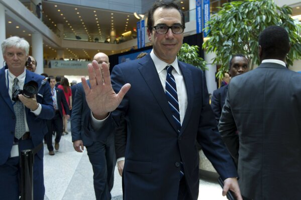 
              Treasury Secretary Steven Mnuchin waves after attending the International Monetary and Financial Committee conference at the World Bank/IMF Spring Meetings in Washington, Saturday, April 13, 2019. (AP Photo/Jose Luis Magana)
            