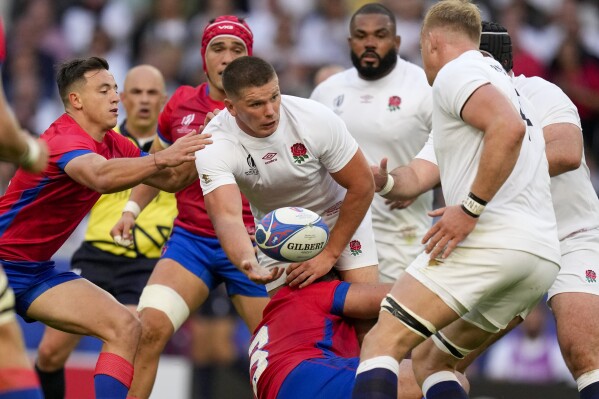 England's Owen Farrell is tackled by Chile's Matias Dittus during the Rugby World Cup Pool D match between England and Chile at the Stade Pierre Mauroy in Villeneuve-d'Ascq, outside Lille, Saturday, Sept. 23, 2023. (AP Photo/Themba Hadebe)