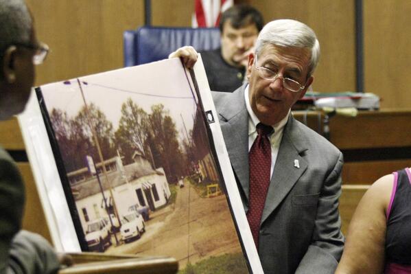FILE - Prosecutor Doug Evans holds a photo during a trial for Curtis Flowers in court on June 14, 2010, in Greenwood, Miss. A federal appeals court on Thursday, June 16, 2022, affirmed the dismissal of a lawsuit that civil rights advocates filed against Evans. The 2019 lawsuit said Evans routinely rejected Black jurors in criminal cases because of their race, and it sought a declaration that Evans’ jury-selection practices violated prospective jurors’ constitutional rights. The appeals court ruled the plaintiffs lacked legal standing because they didn’t show an “immediate threat” that Evans could strike them from jury service. (Taylor Kuykendall/The Commonwealth via AP, File)