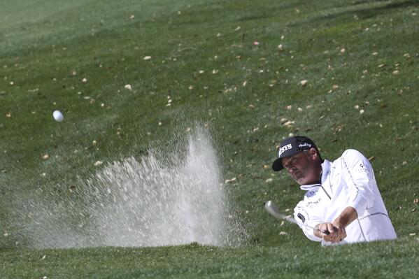 Ryan Palmer hits out of a bunker on the first day of play at the Valero Texas Open at TPC San Antonio, Thursday, March 31, 2022. (Jerry Lara/The San Antonio Express-News via AP)