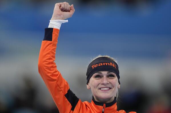 Irene Schouten of the Netherlands reacts during a podium ceremony after winning gold in the women's speedskating mass start final at the 2022 Winter Olympics, Saturday, Feb. 19, 2022, in Beijing. (AP Photo/Ashley Landis)