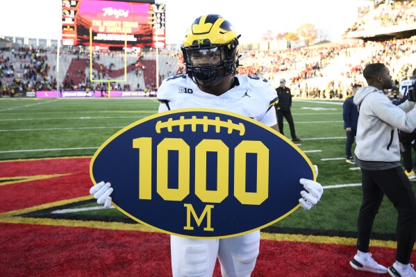 No. 2 Michigan escapes with 31-24 win over Maryland for 1,000th victory in program history | AP News