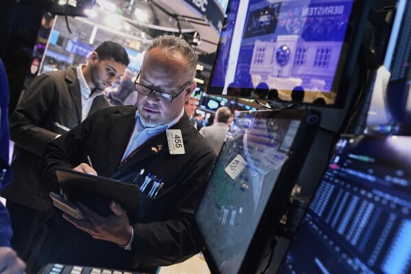 Trader Robert Arciero, right, works on the floor of the New York Stock Exchange, Tuesday, May 27, 2025. (AP Photo/Richard Drew)