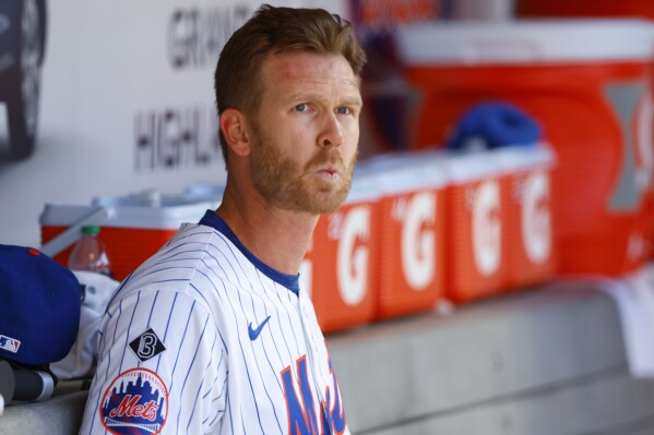 New York Mets relief pitcher Michael Tonkin (51) sits in the dugout during the 11th inning in the first baseball game of a doubleheader, against the Detroit Tigers, Thursday, April 4, 2024, in New York. (AP Photo/Noah K. Murray)