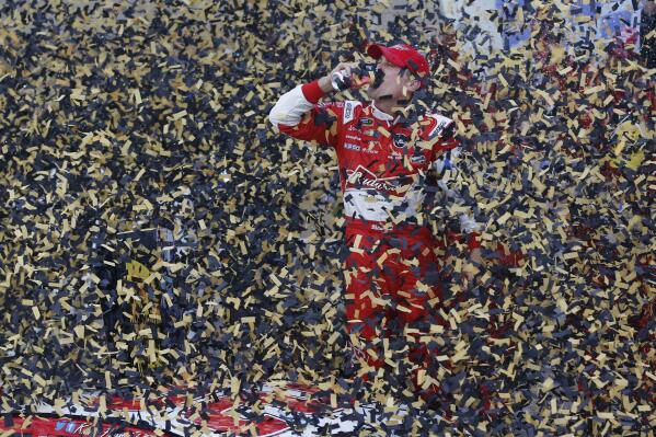 FILE - Driver Kevin Harvick celebrates in victory lane after winning the NASCAR Sprint Cup series auto race at Kansas Speedway in Kansas City, Kan., Sunday, Oct. 6, 2013. Kevin Harvick said Thursday, Jan. 12, 2023, he will retire from NASCAR competition at the end of the 2023 season. (AP Photo/Orlin Wagner, File)
