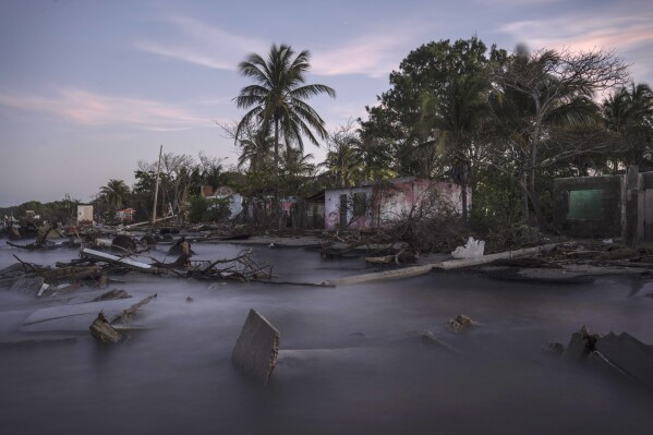 Debris from collapsed home and felled trees litter the shore line of the coastal community of El Bosque, in the state of Tabasco, Mexico, Thursday, Nov. 30, 2023. Flooding driven by a sea-level rise and increasingly brutal winter storms destroyed the Mexican community. (AP Photo/Felix Marquez)