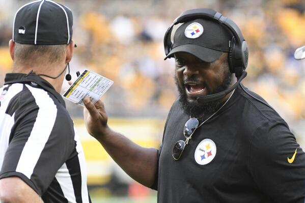 Pittsburgh Steelers head coach Mike Tomlin, right, talks to an official during the first half of a preseason NFL football game against the Seattle Seahawks, Saturday, Aug. 13, 2022, in Pittsburgh. (AP Photo/Fred Vuich)