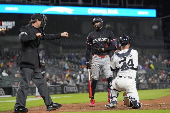 Home plate umpire Adam Beck signals that Minnesota Twins' Carlos Correa has struck out during the third inning of a baseball game against the Detroit Tigers, Friday, April 12, 2024, in Detroit. (AP Photo/Carlos Osorio)