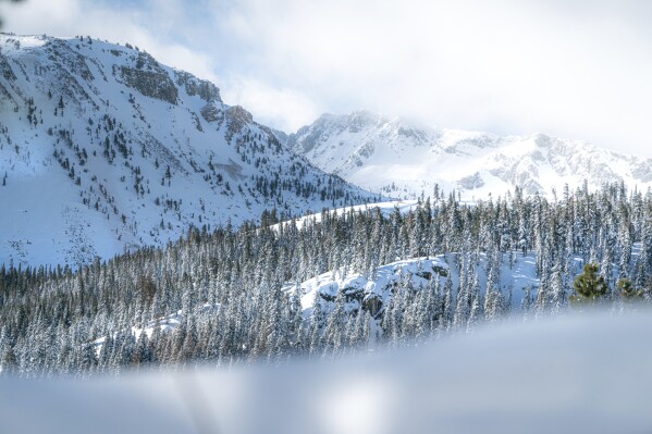 In this photo released by Mammoth Lakes Tourism, snow covers Mammoth Mountain on Tuesday, Feb. 20, 2024, in Mammoth Lakes, Calif. ( Jacob Myhre/Mammoth Lakes Tourism via AP)